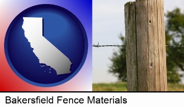 a fence, constructed of wooden posts and barbed wire in Bakersfield, CA