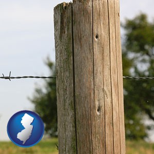 a fence, constructed of wooden posts and barbed wire - with New Jersey icon